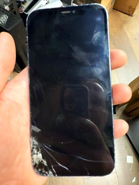 iPhone 12 Pro with visible screen damage before service