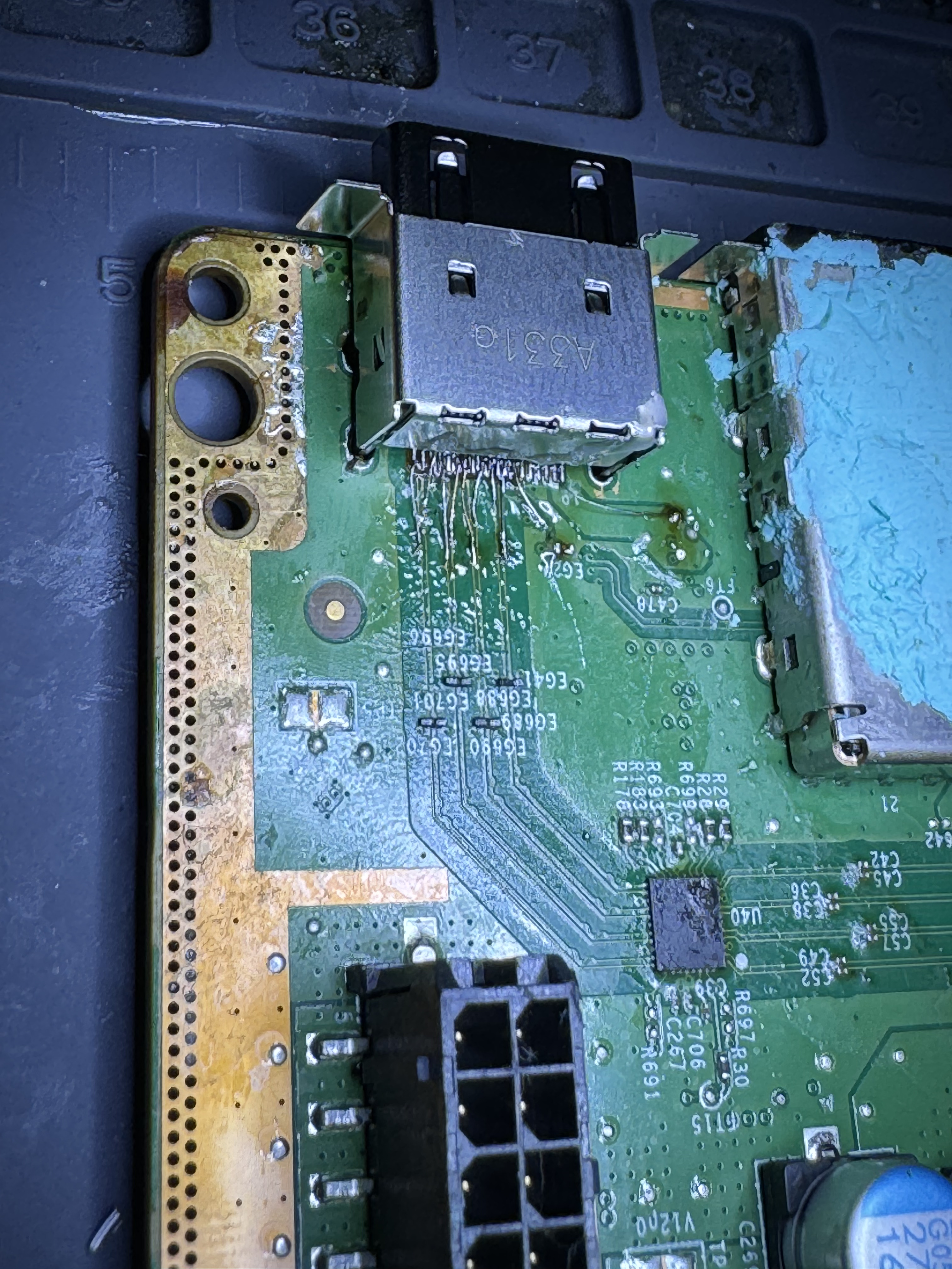 Individual hand-run jumper wires connecting an Xbox Series X HDMI port to surviving pads on the board