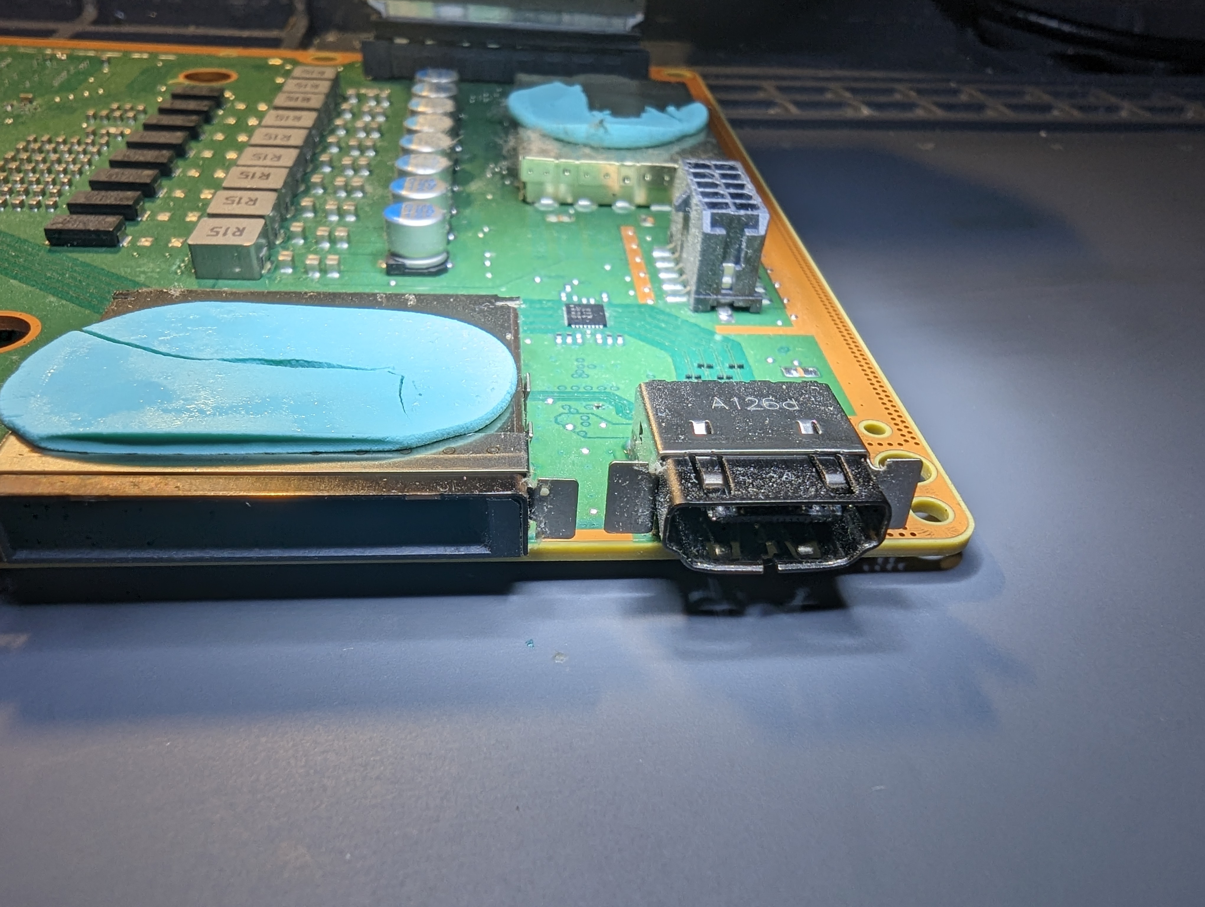 A damaged HDMI port on an Xbox Series X motherboard, bent out of shape