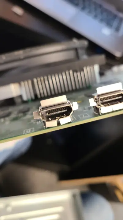 A damaged HDMI port on an Xbox Series X motherboard, bent out of shape