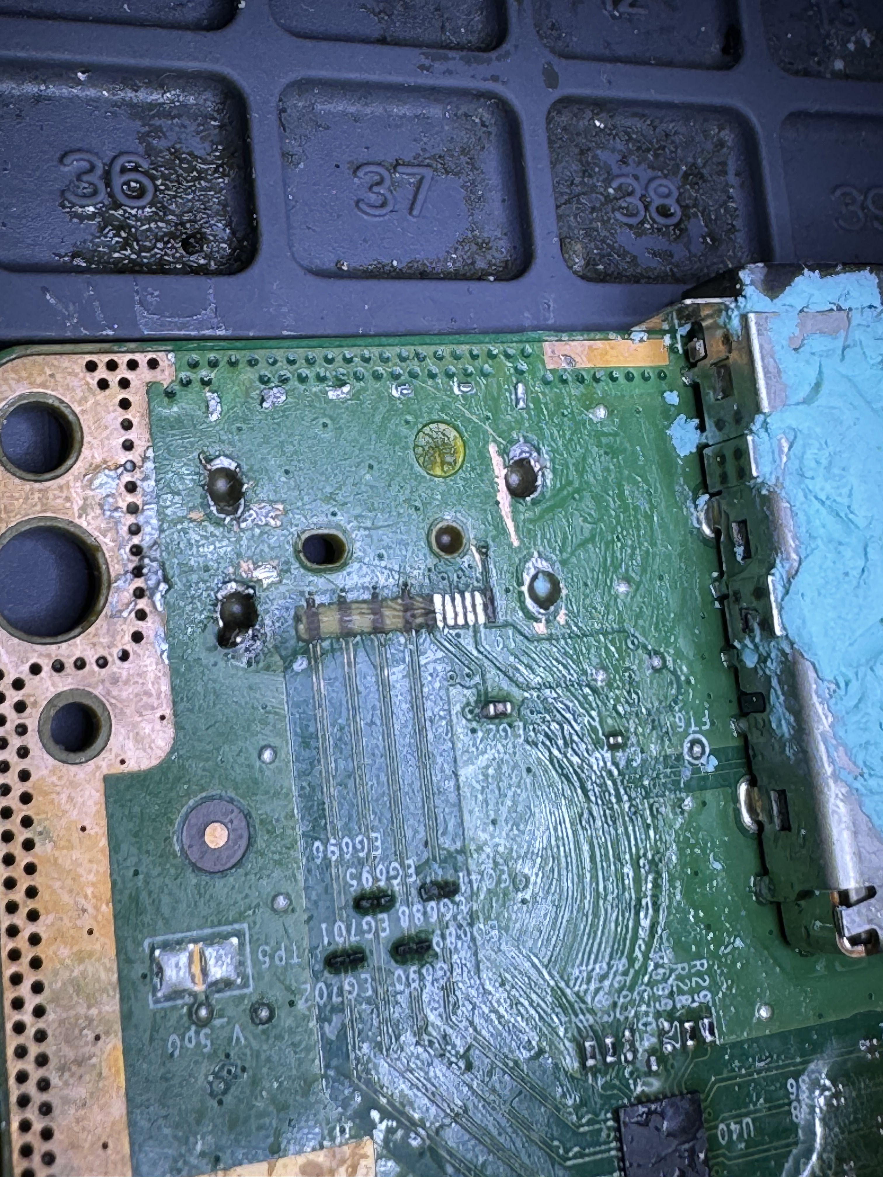 An Xbox Series X motherboard where the HDMI port tore away, leaving damaged and missing pads