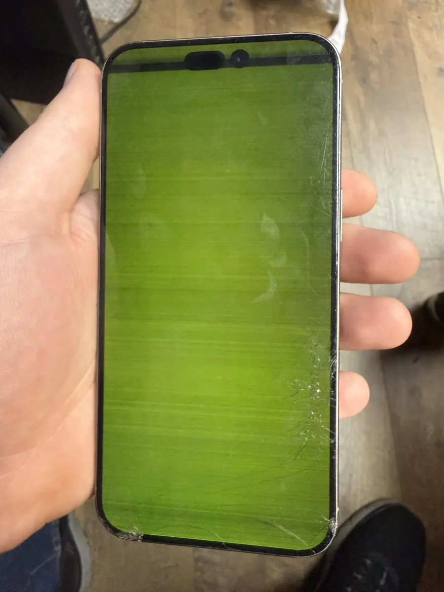iPhone Pro with a green, cracked screen