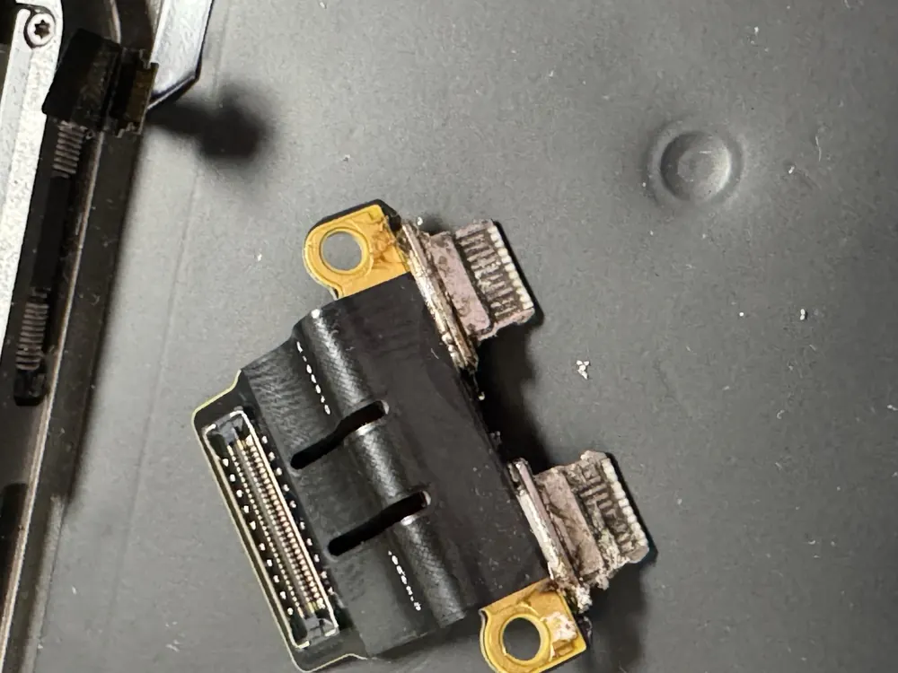 MacBook Pro charge ports, burnt by corrosion before